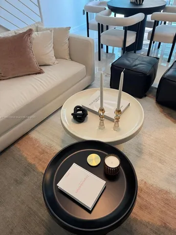 a living room with chairs and a table