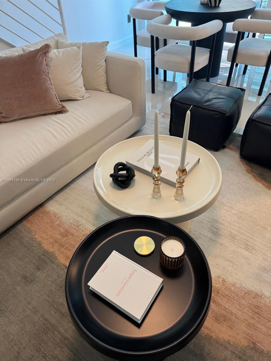 60 Southwest 13th Street, Unit 1406 Miami, FL 33130 - Photo 2 of 19 a living room with chairs and a table