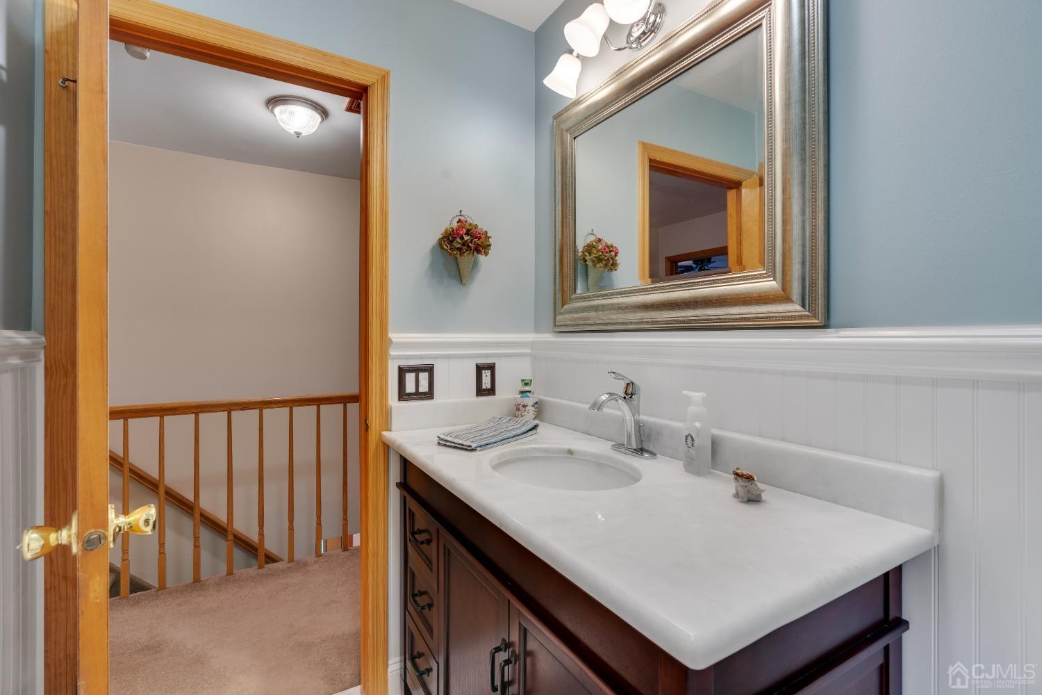 13 Churchill Road Edison, NJ 08820 - Photo 12 of 28 a bathroom with a sink and a mirror