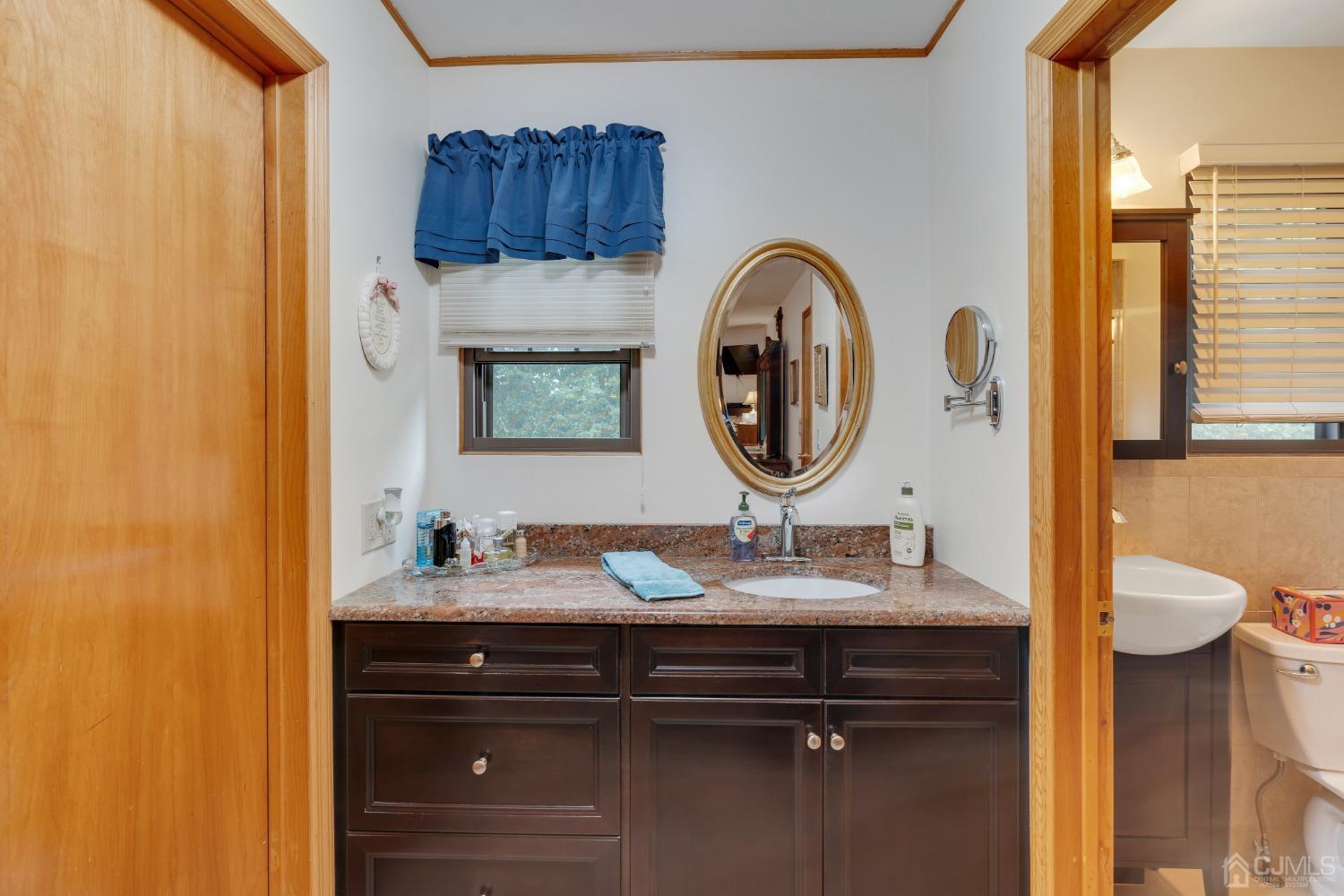 13 Churchill Road Edison, NJ 08820 - Photo 13 of 28 a bathroom with a sink and a mirror