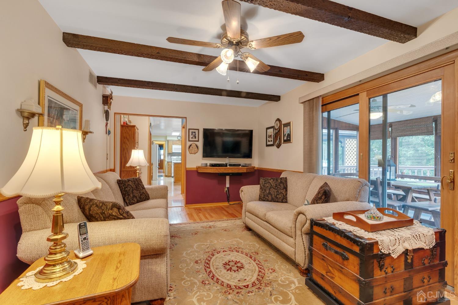 13 Churchill Road Edison, NJ 08820 - Photo 22 of 28 a living room with furniture and a flat screen tv