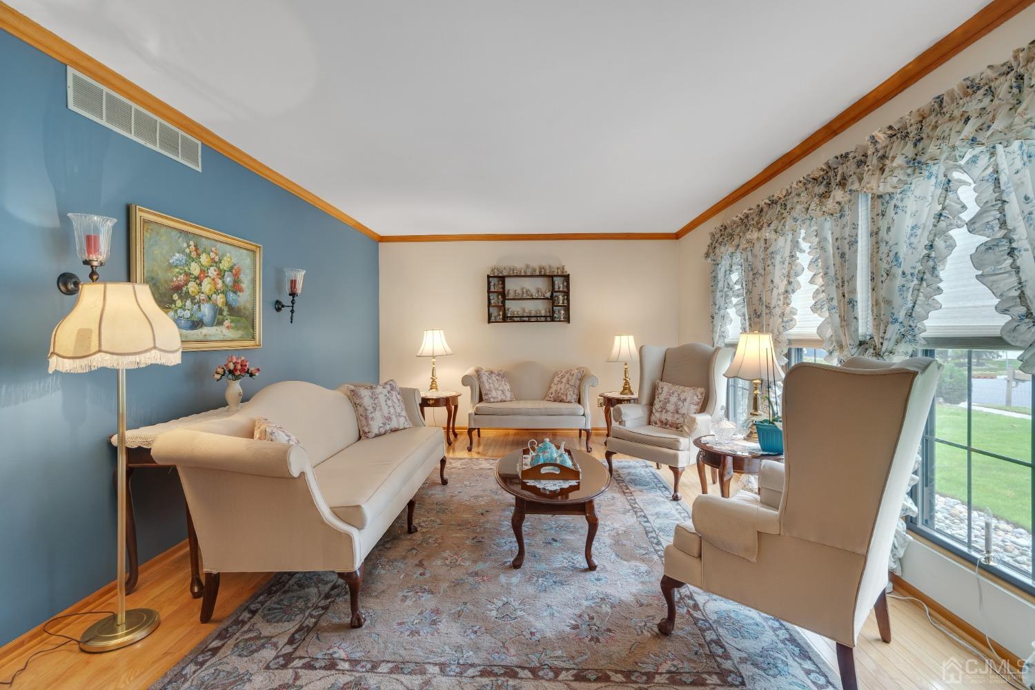 13 Churchill Road Edison, NJ 08820 - Photo 24 of 28 a living room with furniture a lamp and a large window with rug