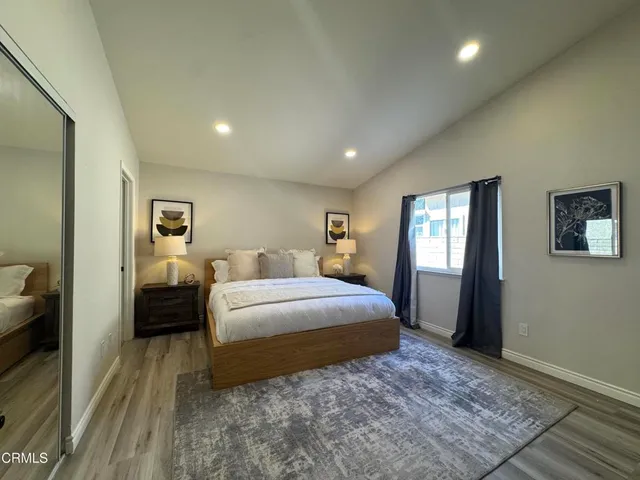 a spacious bedroom with a bed and a couch