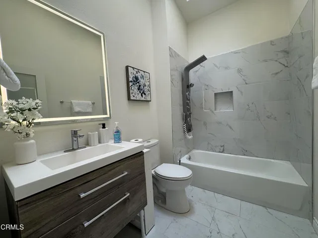 a bathroom with a sink a toilet and a bathtub
