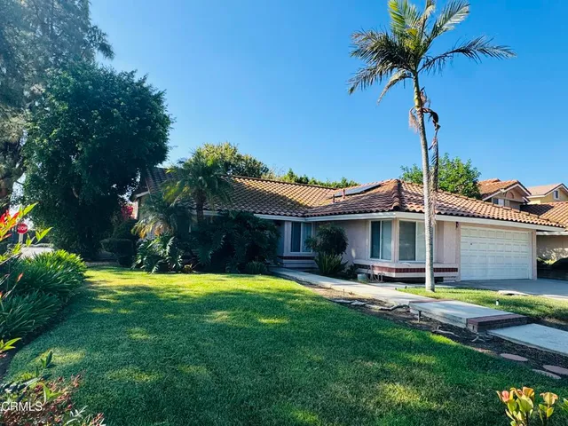 a view of a house with pool and a yard