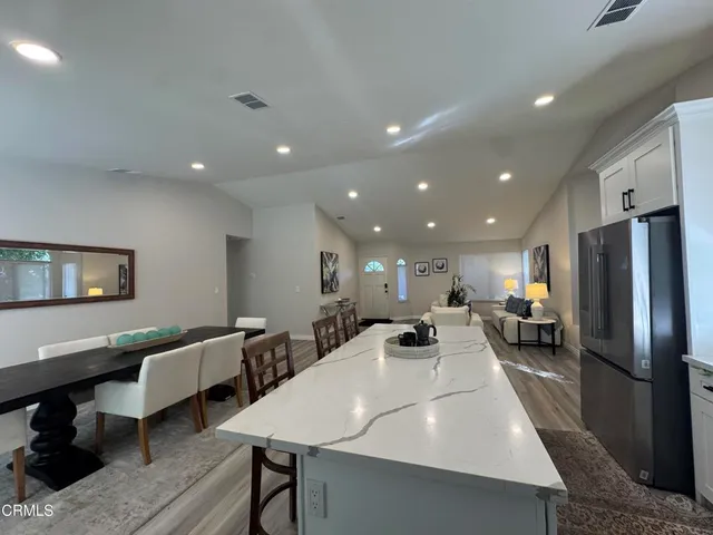 a large kitchen with a table and chairs