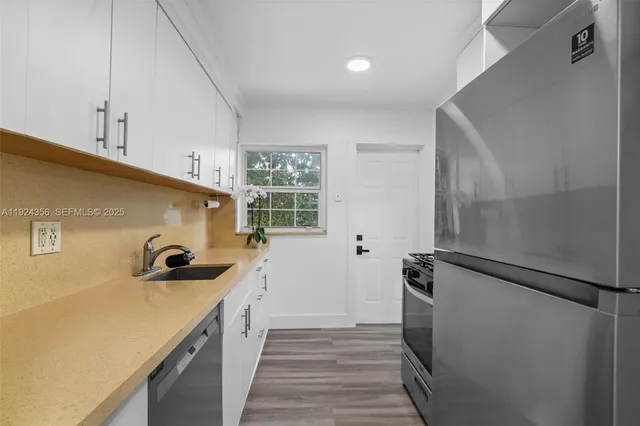 a kitchen with a sink and refrigerator