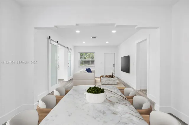 a living room with furniture kitchen and a table