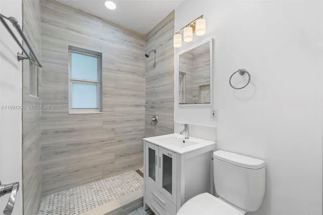 a bathroom with a sink toilet and shower