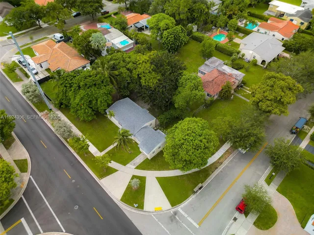 an aerial view of a house with a garden and lake view