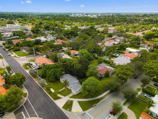 an aerial view of residential houses with outdoor space
