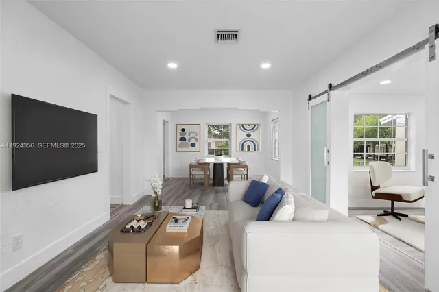 a living room with furniture and a flat screen tv