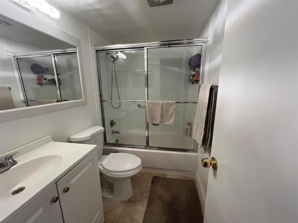 418 Durham, Unit 418 Deerfield Beach, FL 33442 - Photo 12 of 47 a bathroom with a sink toilet and shower