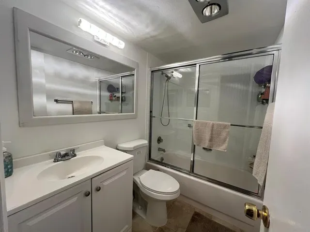 a bathroom with a toilet sink and shower