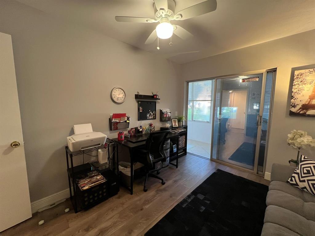 418 Durham, Unit 418 Deerfield Beach, FL 33442 - Photo 18 of 47 a view of a workspace with furniture and a chandelier fan