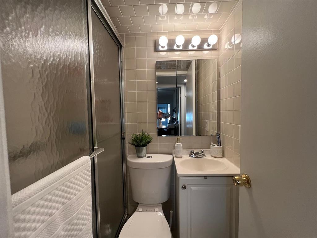 418 Durham, Unit 418 Deerfield Beach, FL 33442 - Photo 19 of 47 a bathroom with a sink and mirror with toilet