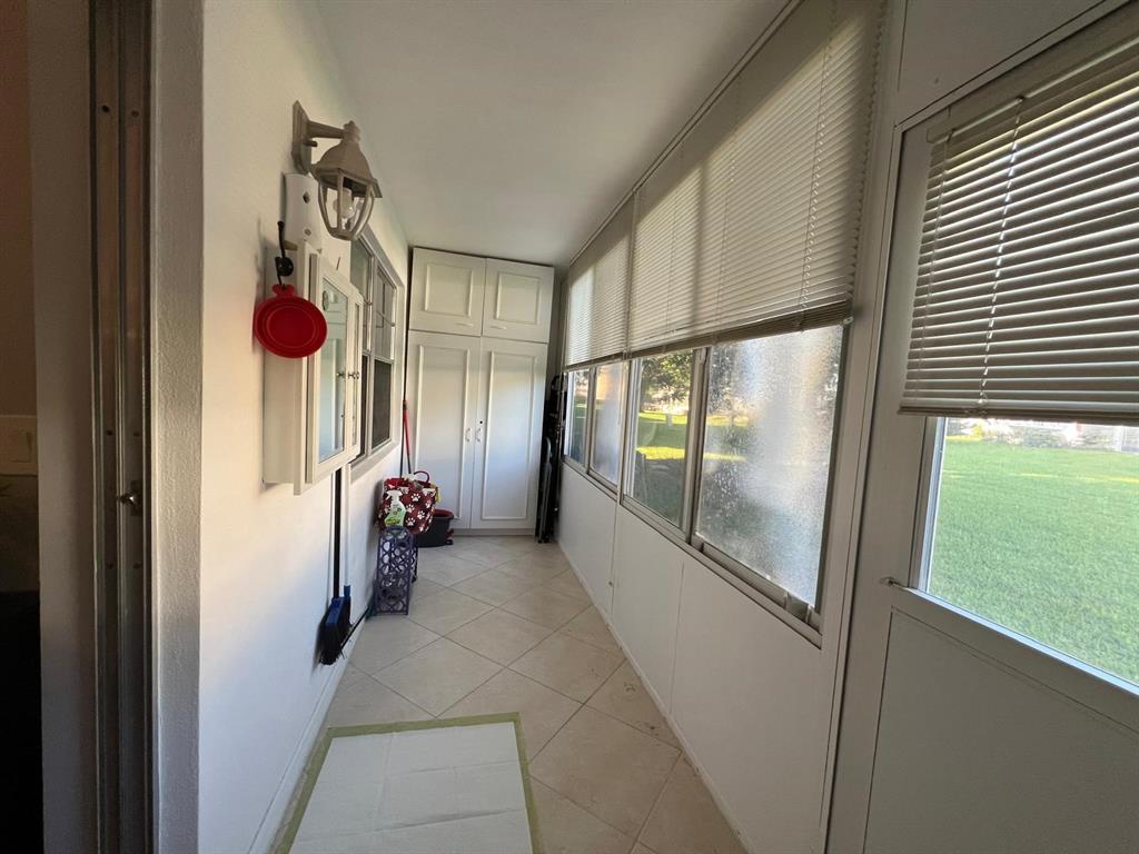 418 Durham, Unit 418 Deerfield Beach, FL 33442 - Photo 20 of 47 a hallway with sliding door and windows