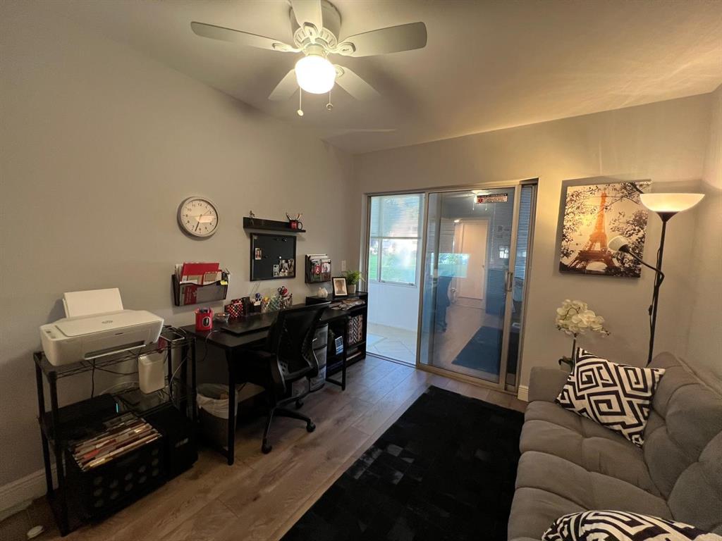 418 Durham, Unit 418 Deerfield Beach, FL 33442 - Photo 21 of 47 a view of a livingroom with furniture and a chandelier