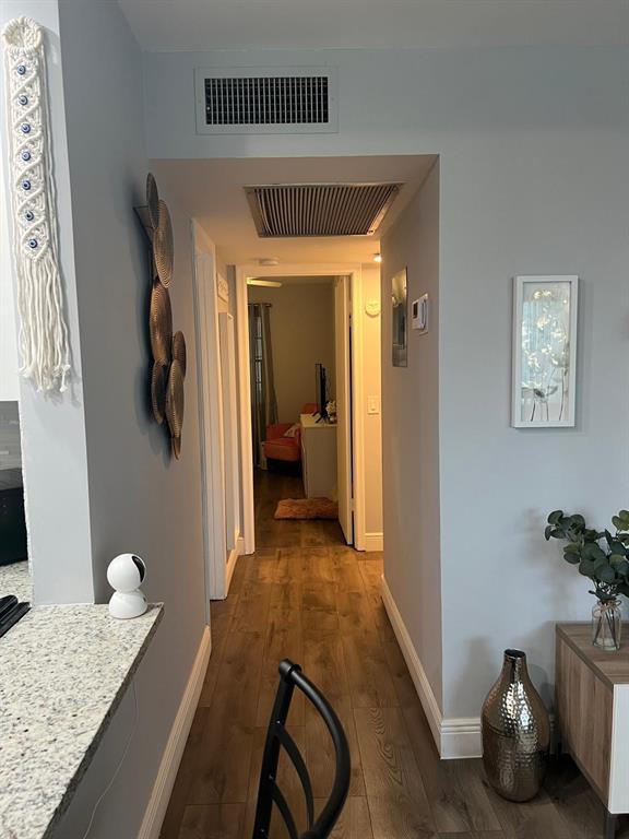 418 Durham, Unit 418 Deerfield Beach, FL 33442 - Photo 6 of 47 a bedroom with a bed and wooden floor