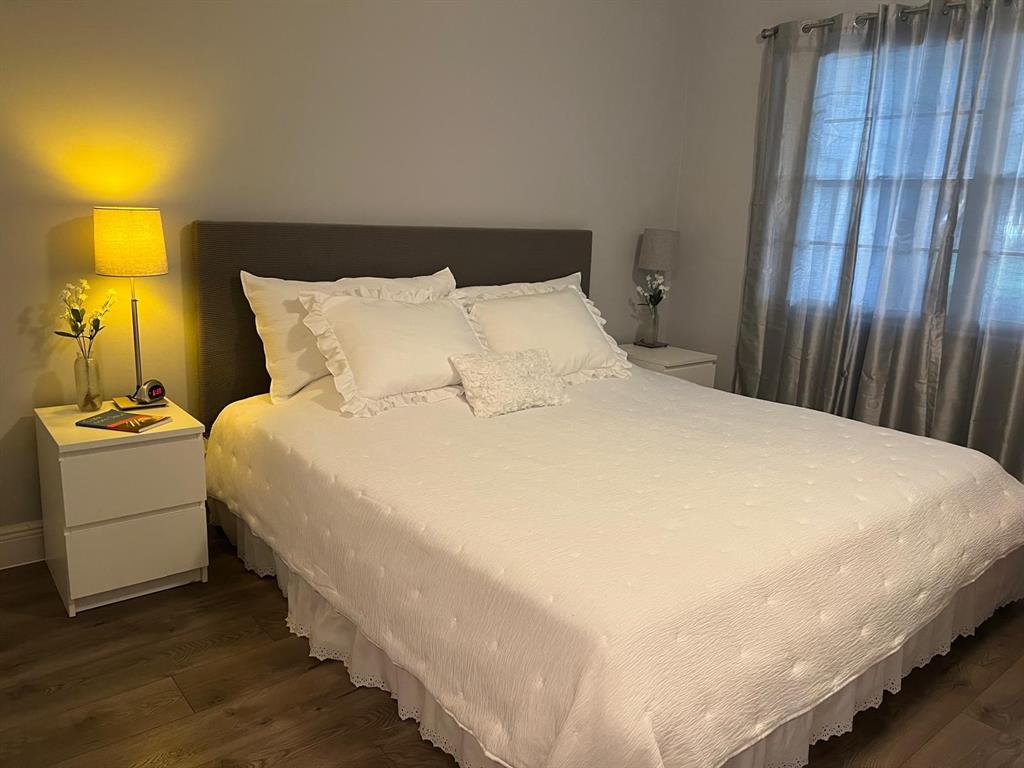 418 Durham, Unit 418 Deerfield Beach, FL 33442 - Photo 9 of 47 a large bed sitting in a bedroom next to a lamp