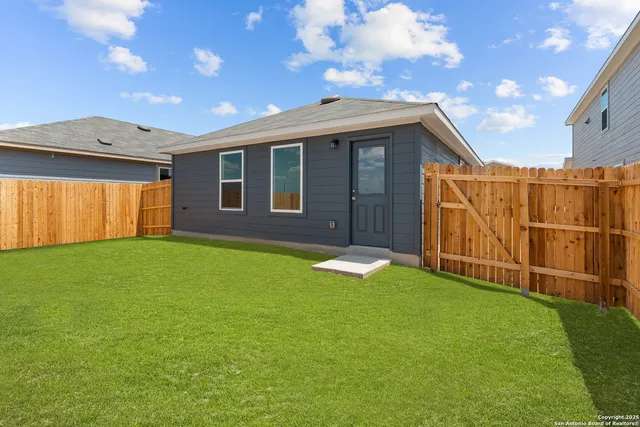 a view of an house with backyard and porch