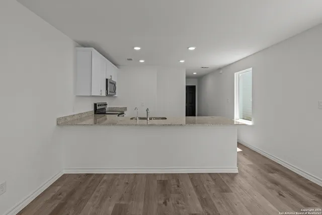 a view of a kitchen with wooden floor