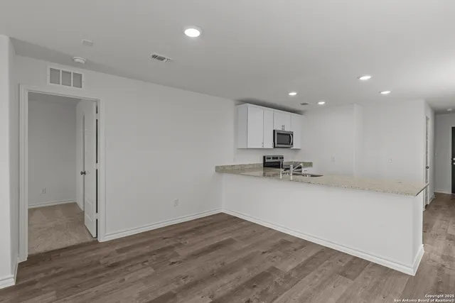 a view of a kitchen with wooden floor