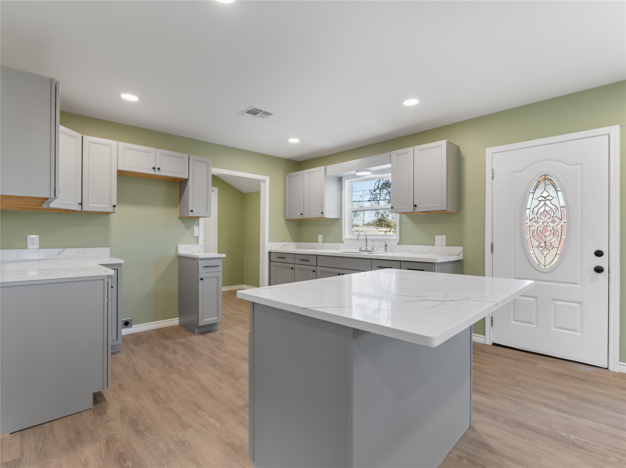 2110 Horn Road Bay City, TX 77414 - Photo 4 of 11 a kitchen with cabinets and wooden floor