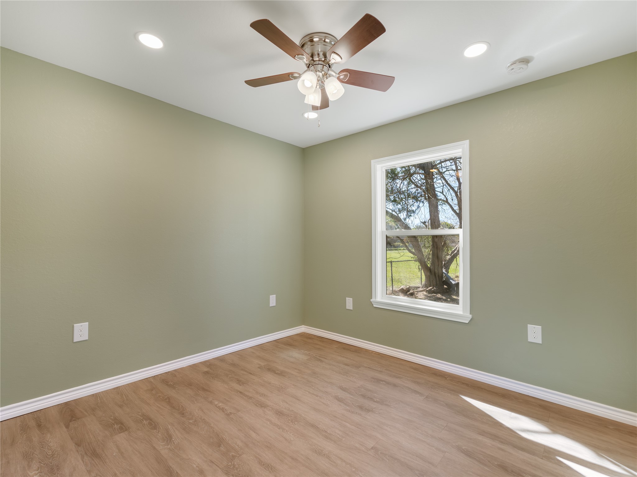 2110 Horn Road Bay City, TX 77414 - Photo 6 of 11 an empty room with windows and fan