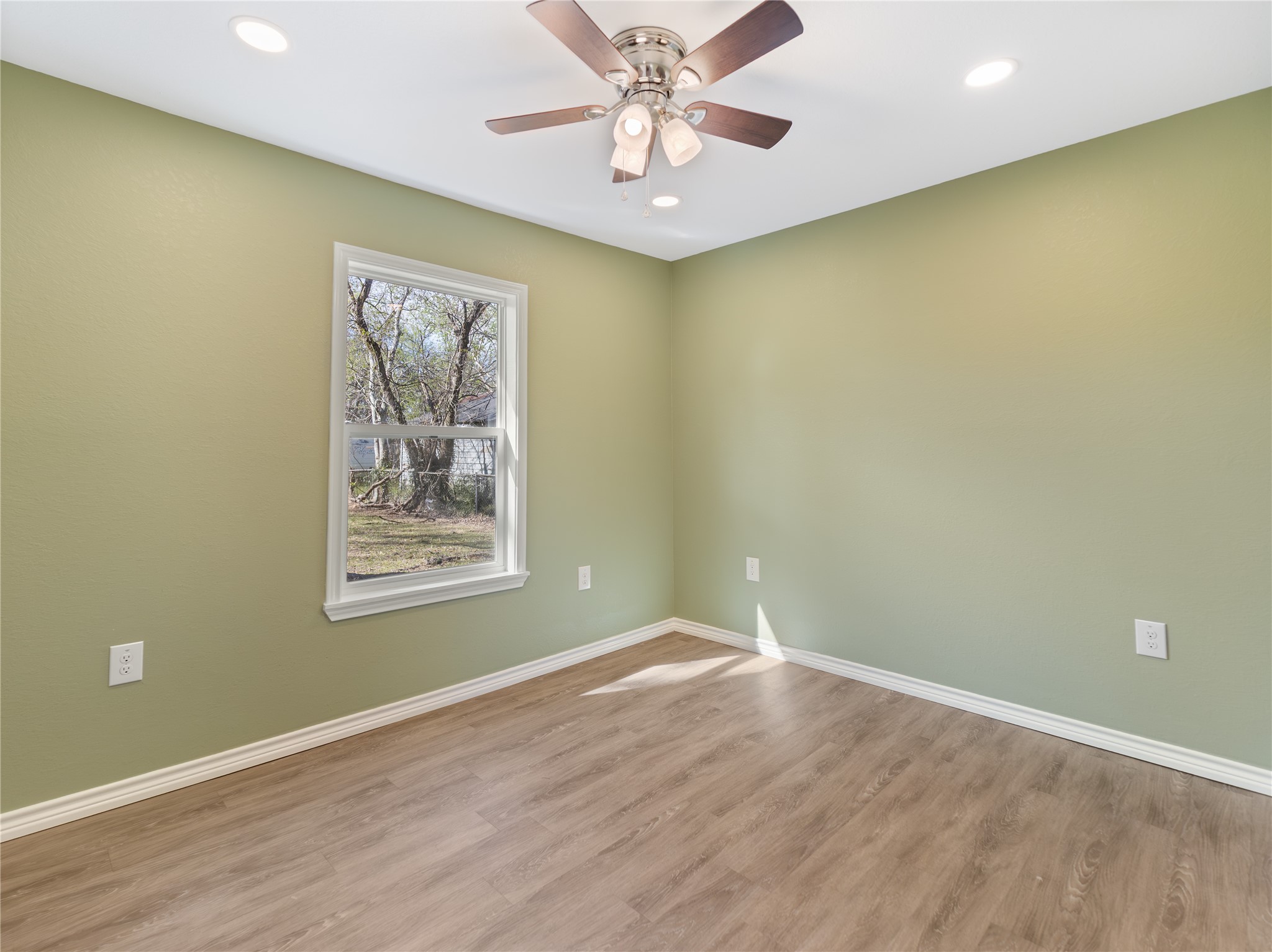 2110 Horn Road Bay City, TX 77414 - Photo 8 of 11 an empty room with a window and a fan