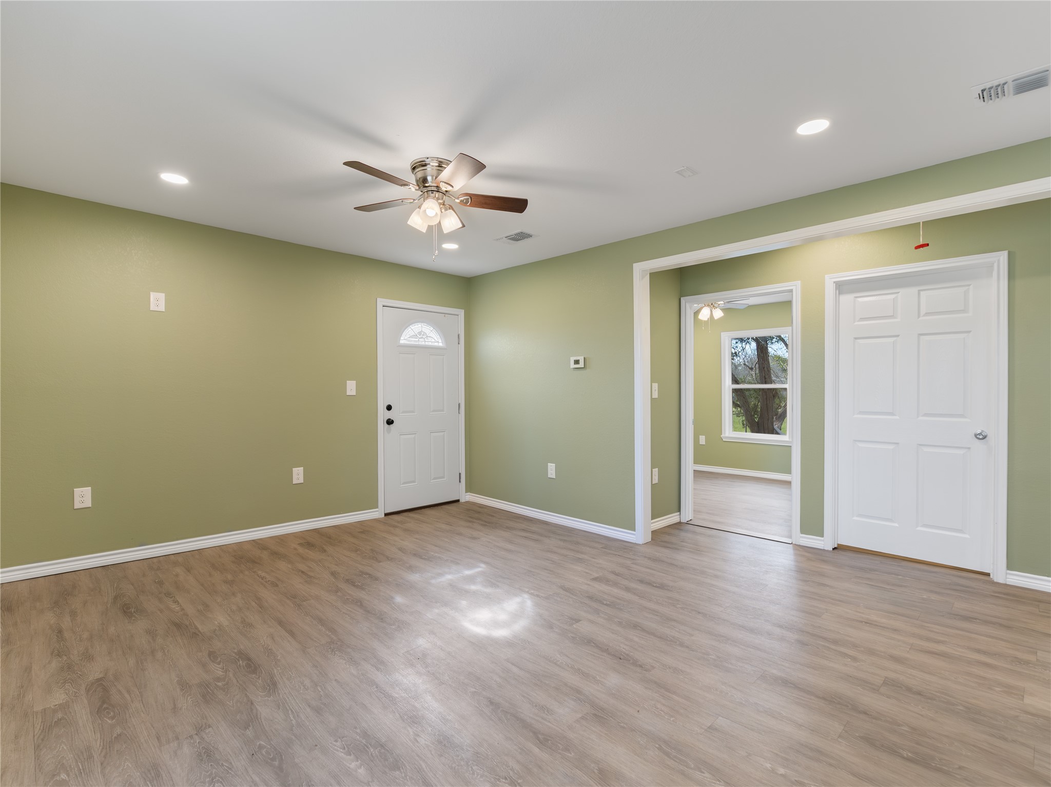 2110 Horn Road Bay City, TX 77414 - Photo 10 of 11 an empty room with wooden floor and windows