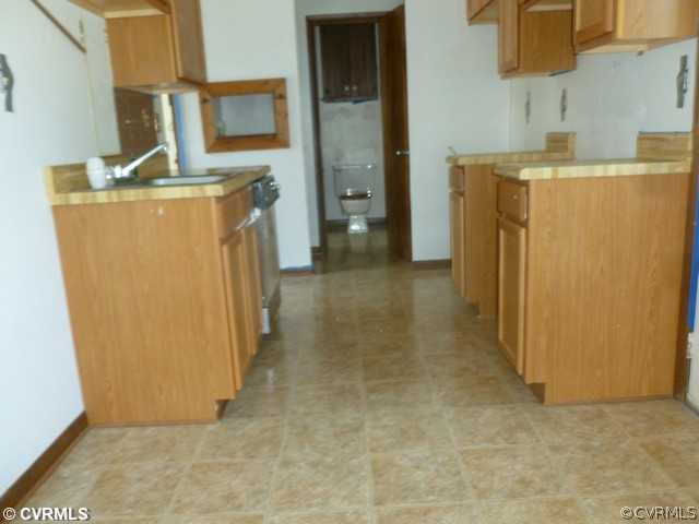 15916 Tri Gate Road Chester, VA 23831 - Photo 3 of 7 a view of a storage & utility room with a refrigerator