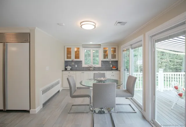 a dining room with furniture and wooden floor