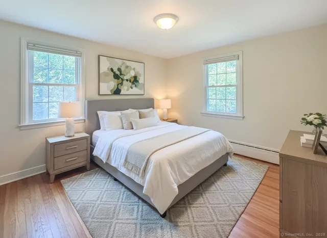 a bedroom with a large bed and a window