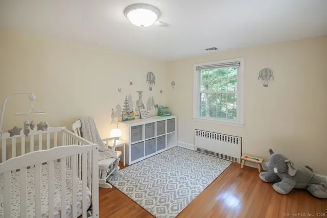 a view of a room with wooden floor and windows