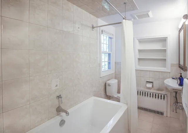 a bathroom with a bathtub and a sink