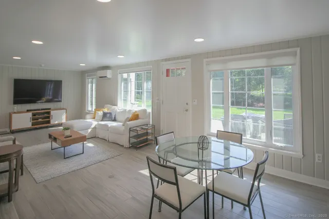 a living room with fireplace furniture and a flat screen tv