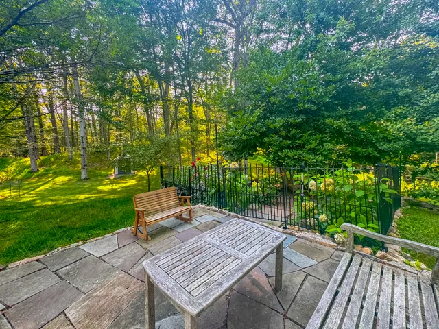 a wooden bench sitting in middle of a yard