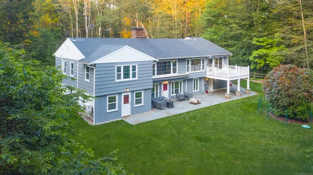a aerial view of a house with a yard table and chairs