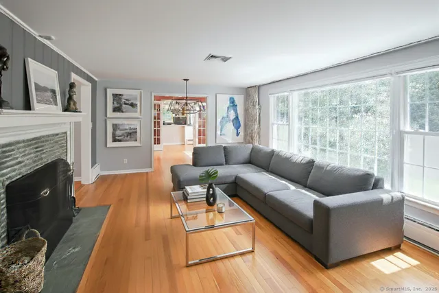 a living room with furniture and a fireplace
