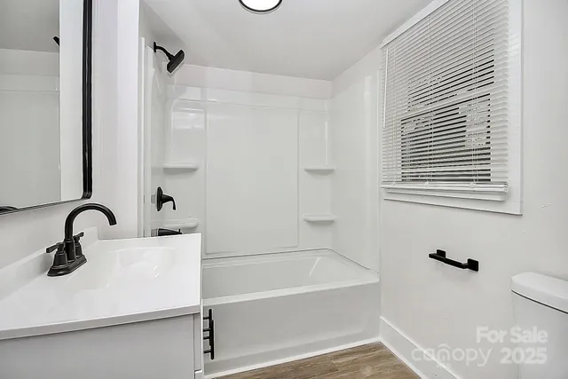 a bathroom with a sink a mirror and a bathtub