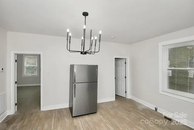 a kitchen with stainless steel appliances a refrigerator and cabinets