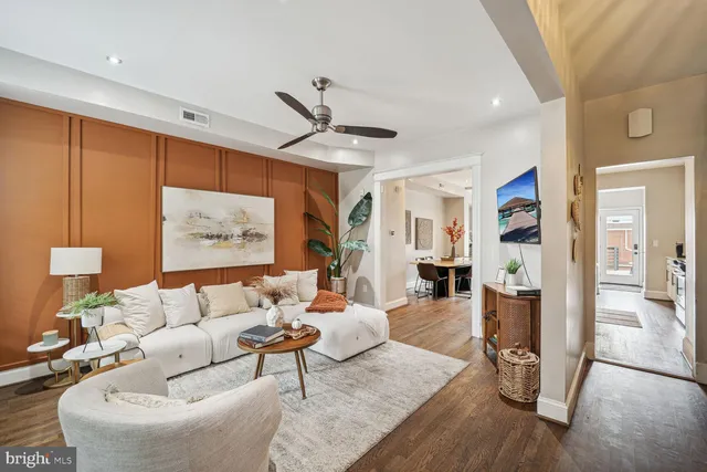 a living room with furniture and wooden floor
