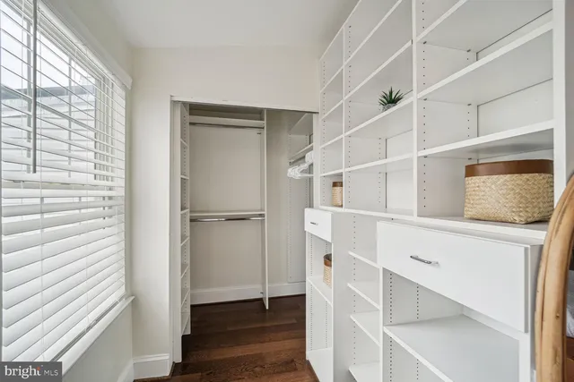 a view of an entryway with wooden floor and cabinet