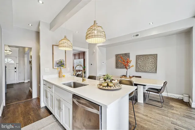 a view of a dining room with furniture wooden floor and a chandelier