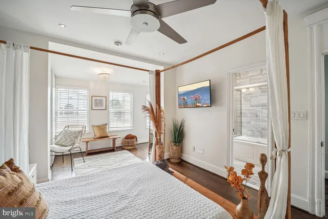 a bedroom with furniture and a large window