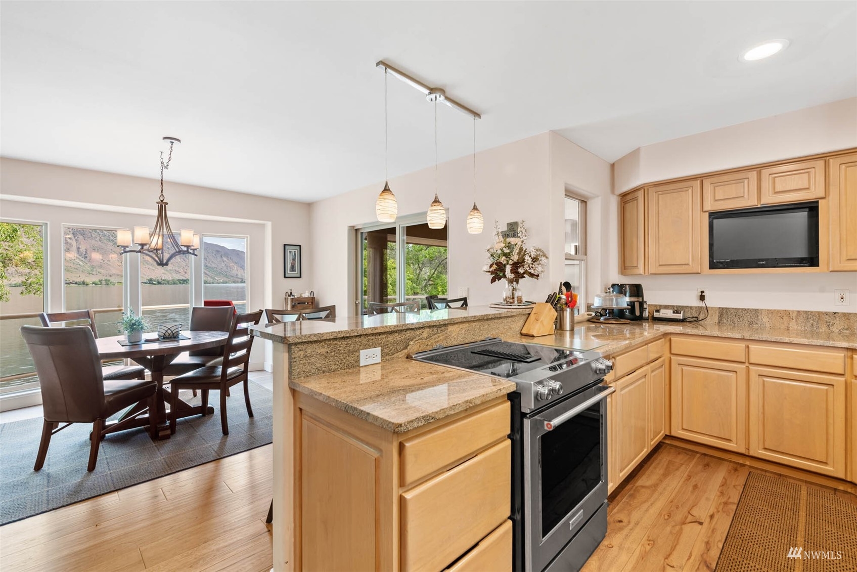 13699 Whitebird Place Orondo, WA 98843 - Photo 17 of 36 a kitchen with a stove cabinets and dining table