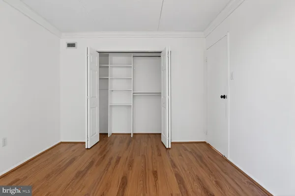 a view of a room with wooden floor
