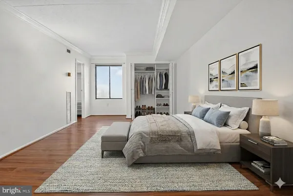 a bedroom with a bed and wooden floor