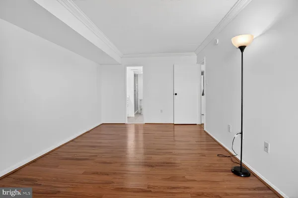 a view of an empty room and wooden floor